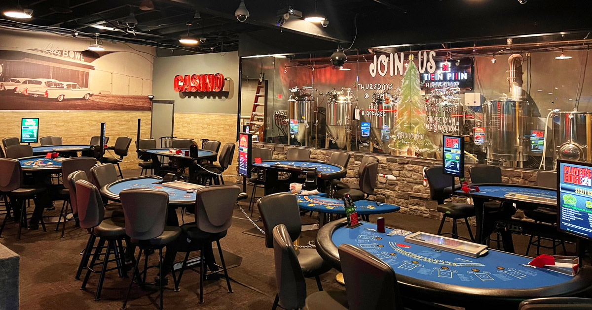 Casino gaming room with brewing equipment in the background
